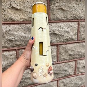 Brand new 12” wax lighthouse and seashell candle